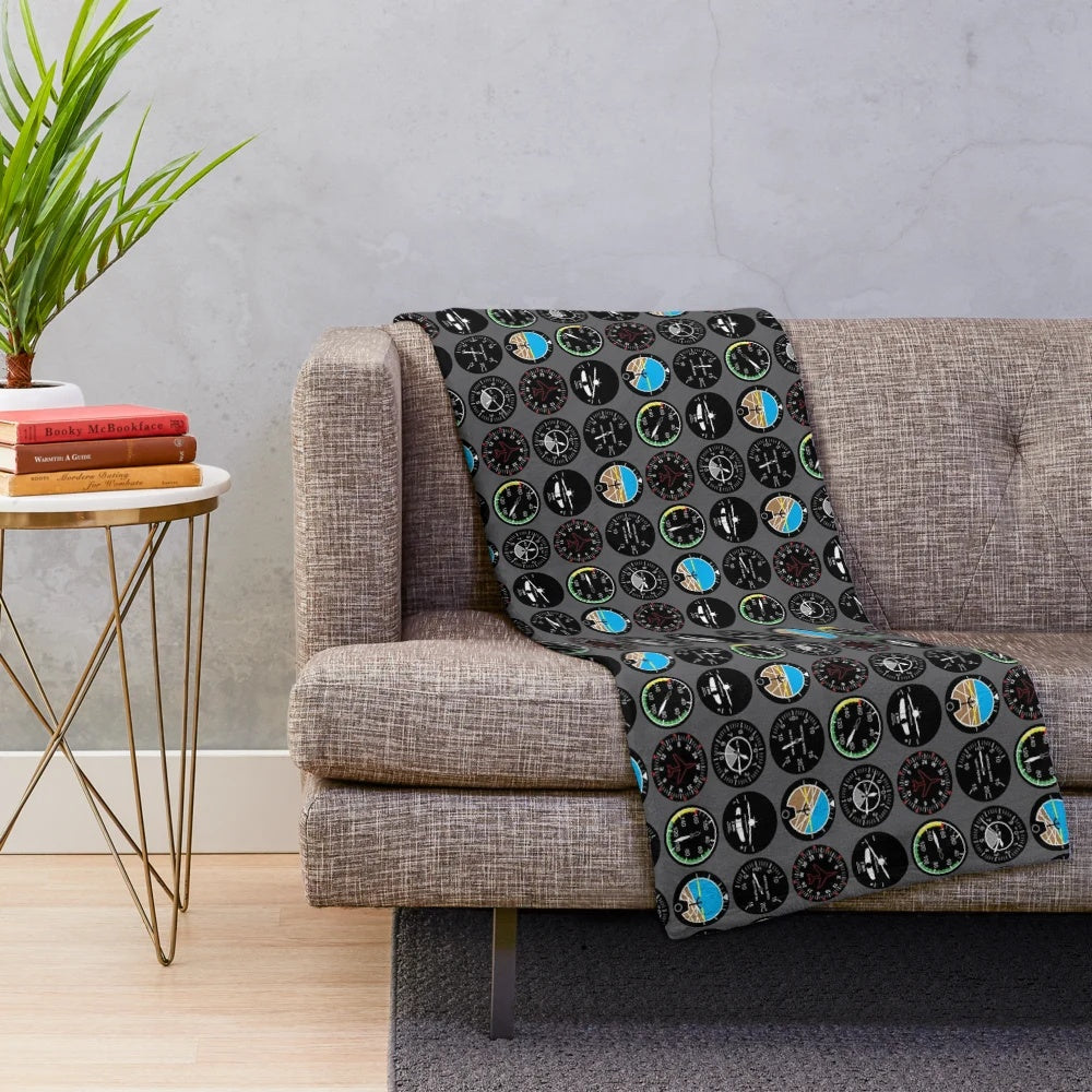 Plush flight instruments blanket featuring various aviation symbols and designs
