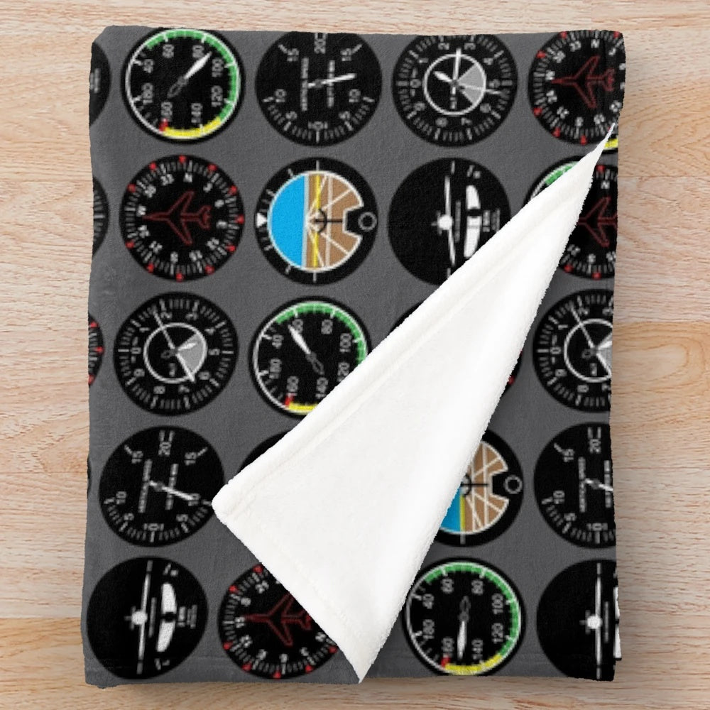 Plush flight instruments blanket featuring various aviation symbols and designs