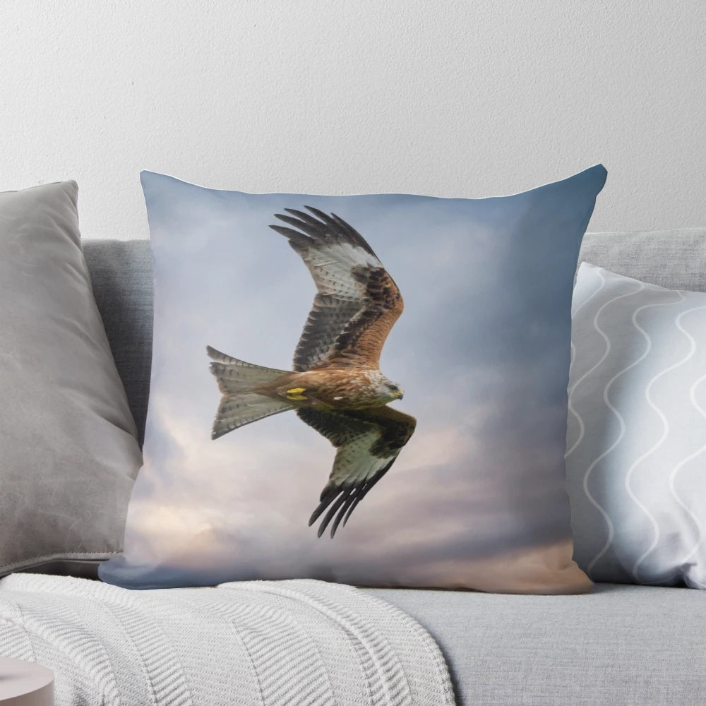 A vibrant red kite soaring through the sky on a decorative throw pillow