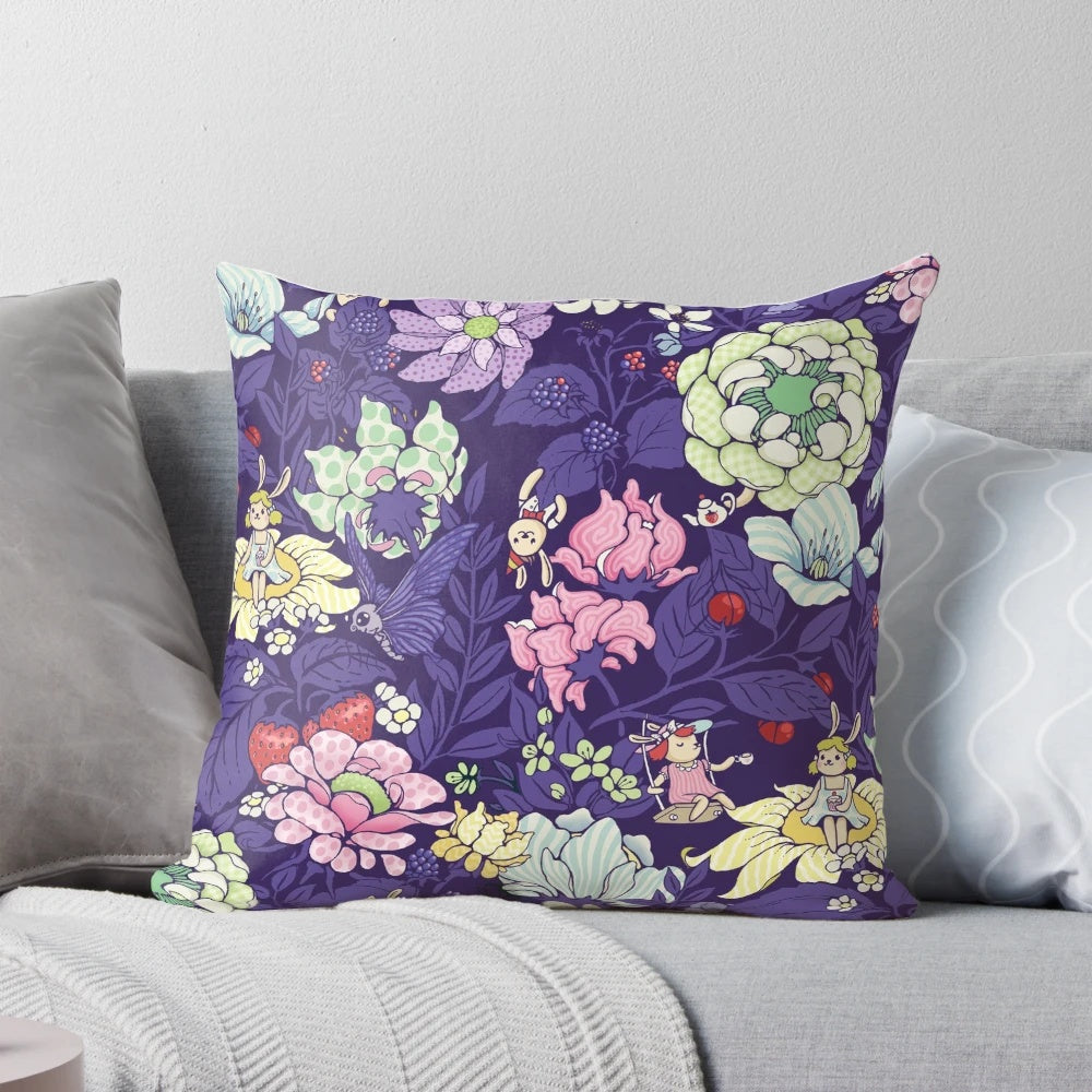 A plush, decorative pillow featuring a whimsical garden party design with bunnies, flowers, and blueberry tea.
