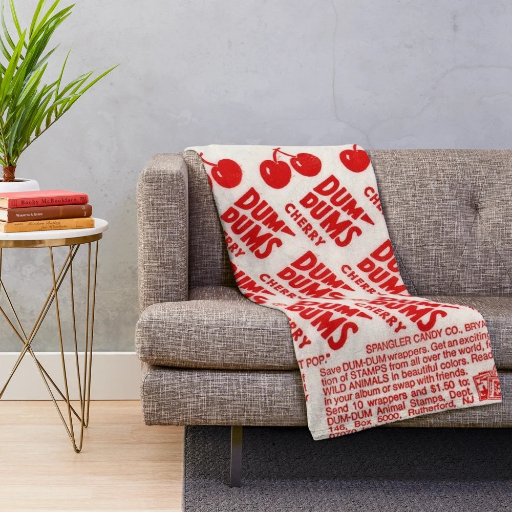 Cherry dum dum plush blanket with a lollipop design