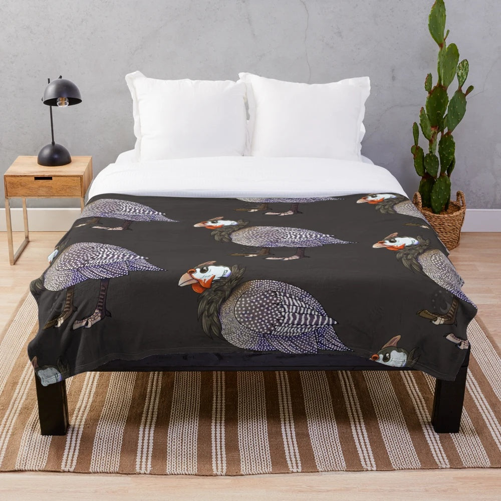 A soft and plush blanket featuring the beautiful helmeted guinea fowl bird design