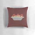A soft and plush pillow featuring a knitting design and spaghetti and meatballs motif.