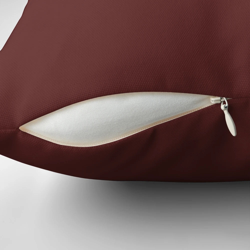 A soft and plush pillow featuring a knitting design and spaghetti and meatballs motif.
