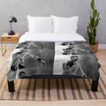 Soft and cozy plush blanket with black and white design, perfect for music fans