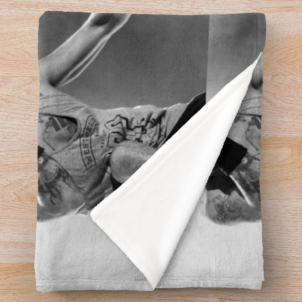Soft and cozy plush blanket with black and white design, perfect for music fans