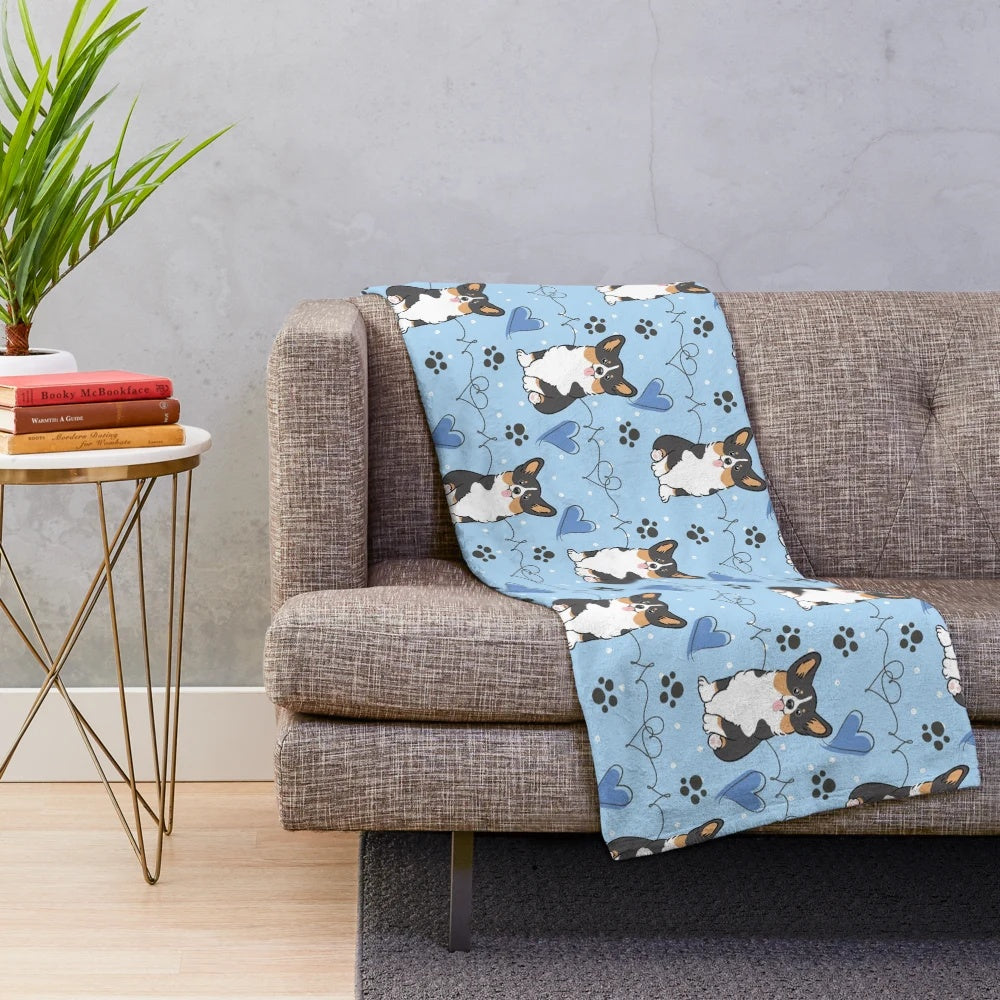 Black tri color corgi on a plush blanket