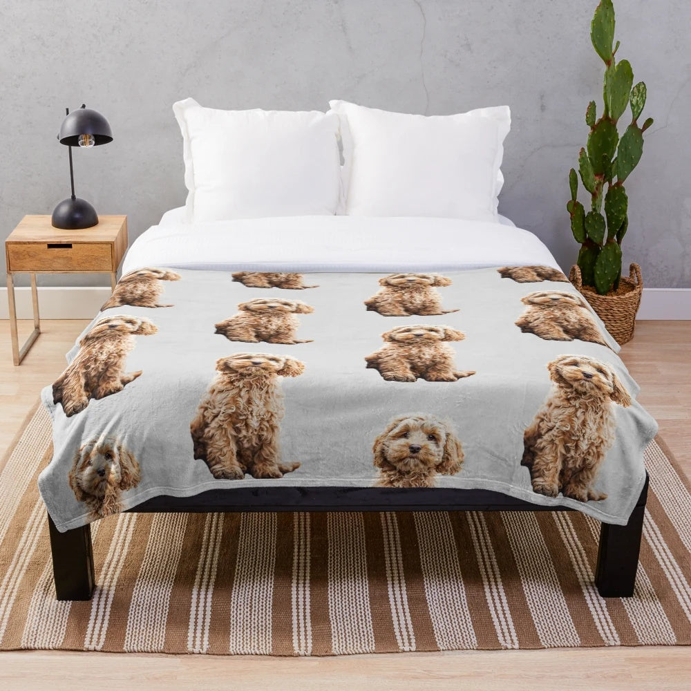 Adorable poodle mix puppy on a soft, plush blanket