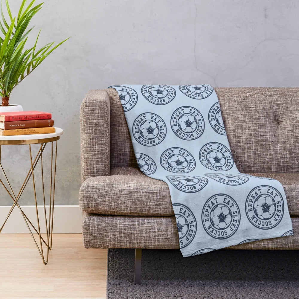 Soccer plush blanket featuring a soccer ball design