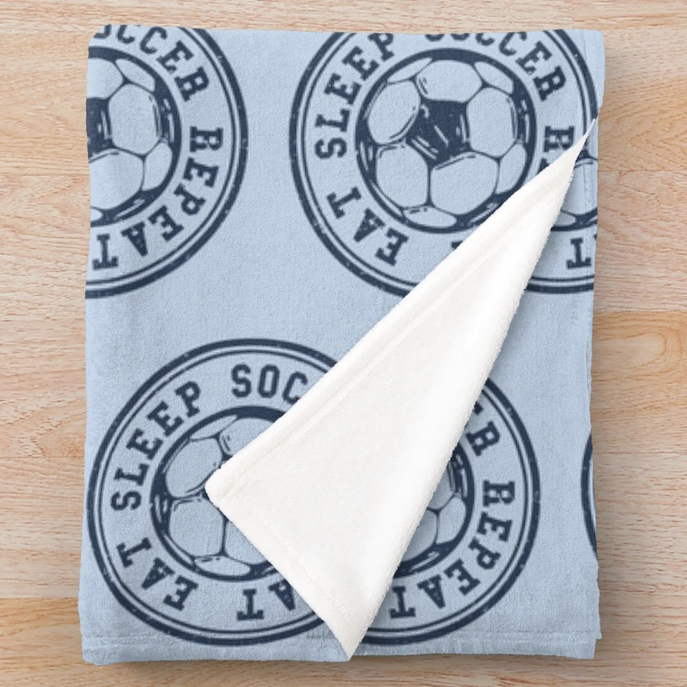 Soccer plush blanket featuring a soccer ball design