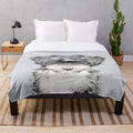 Tibetan Terrier dog portrait on a plush black and white blanket