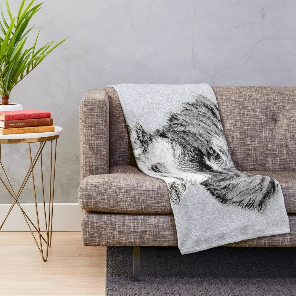 Tibetan Terrier dog portrait on a plush black and white blanket