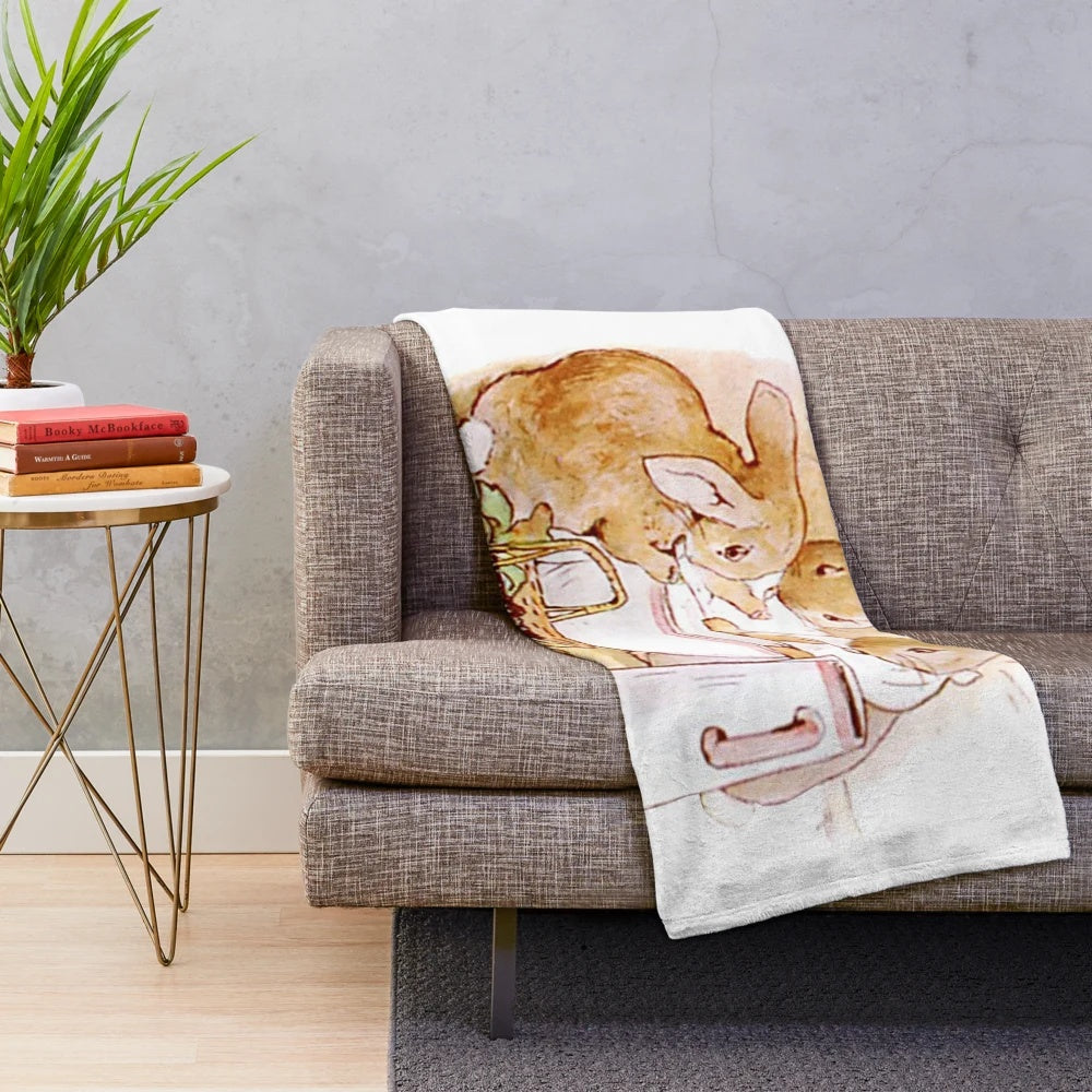 Flopsy, Mopsy and Cottontail plush blanket featuring characters from the Peter Rabbit stories by Beatrix Potter