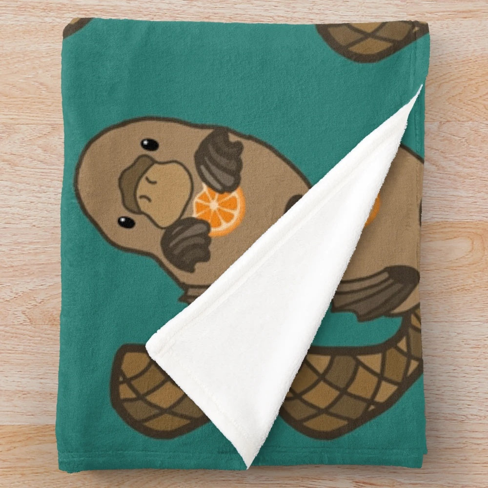 Orange plush blanket with a cute platypus design
