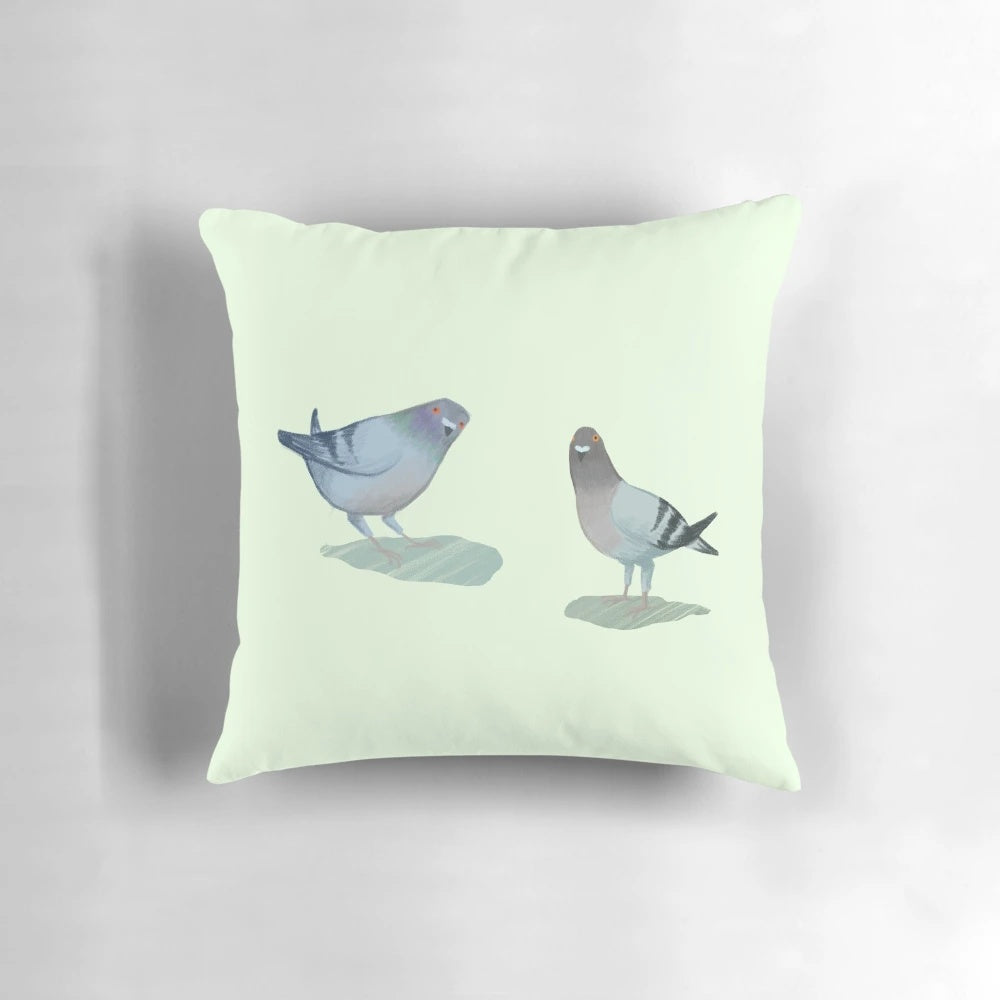 A cozy throw pillow featuring a pair of adorable pigeons in a natural setting.