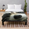 Soft and cozy plush blanket with a cute raccoon face design