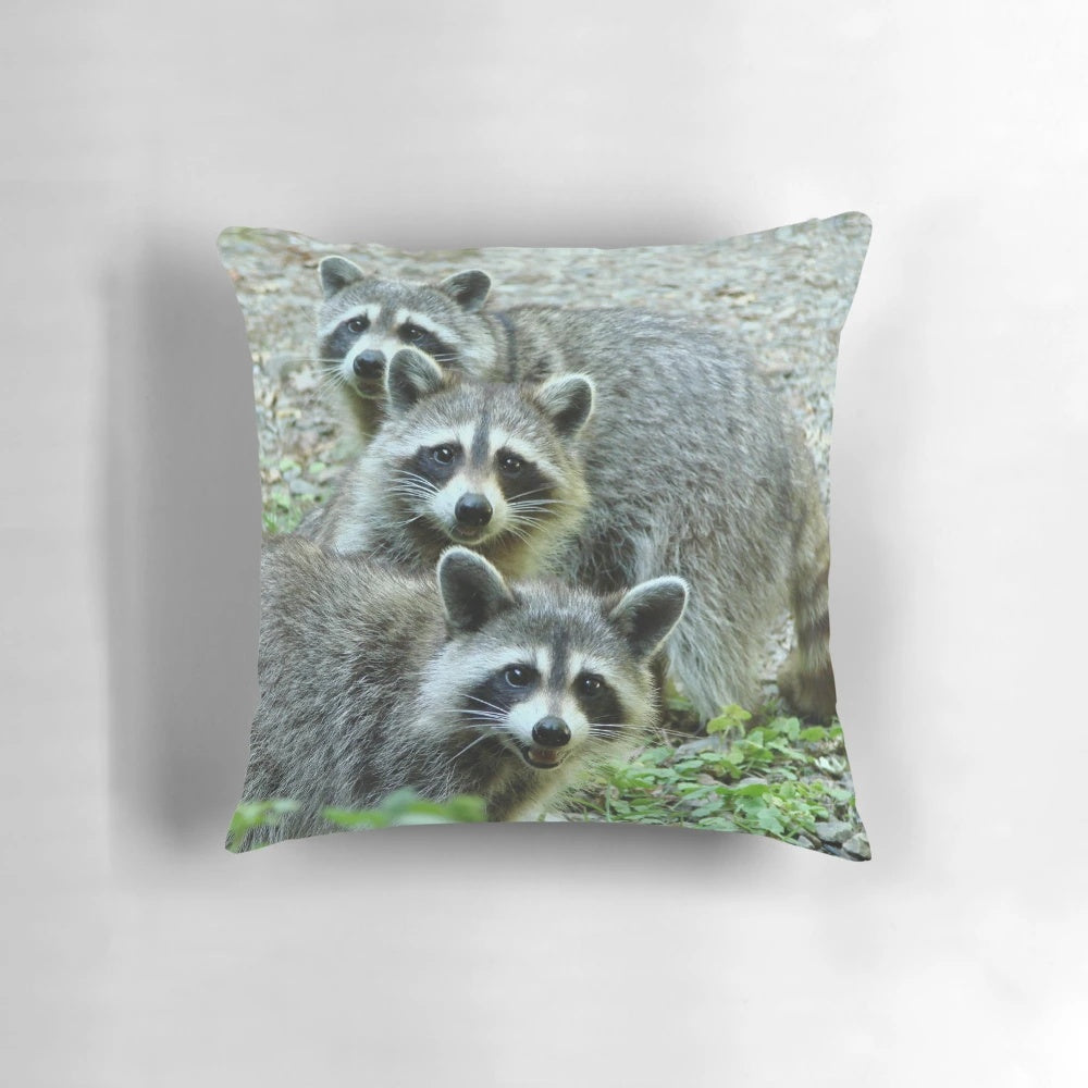 A cozy gray and black raccoon-themed throw pillow