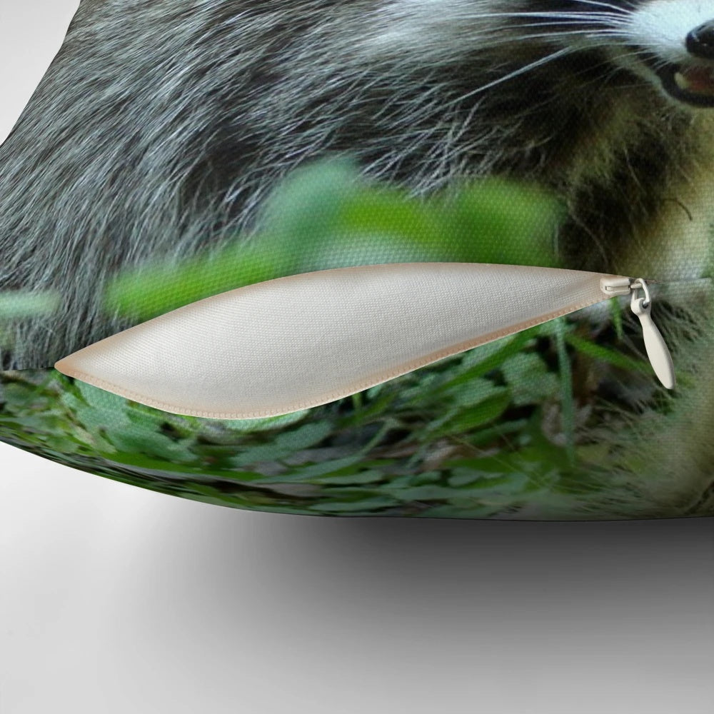 A cozy gray and black raccoon-themed throw pillow