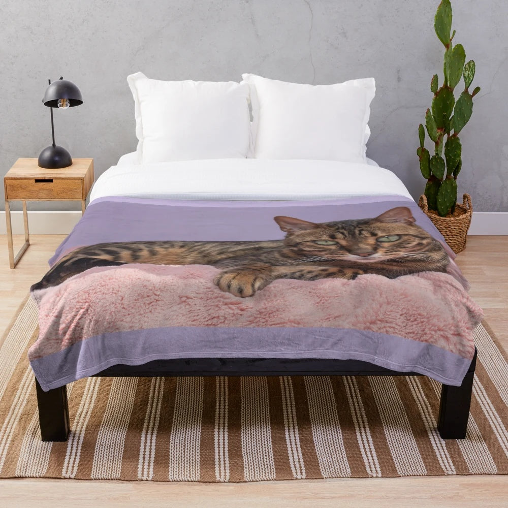 Cozy plush blanket featuring a beautiful bengal cat or asian leopard cat with striking spots and green eyes
