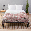 Soft and cozy plush blanket with a minimalist Japanese cherry blossom design