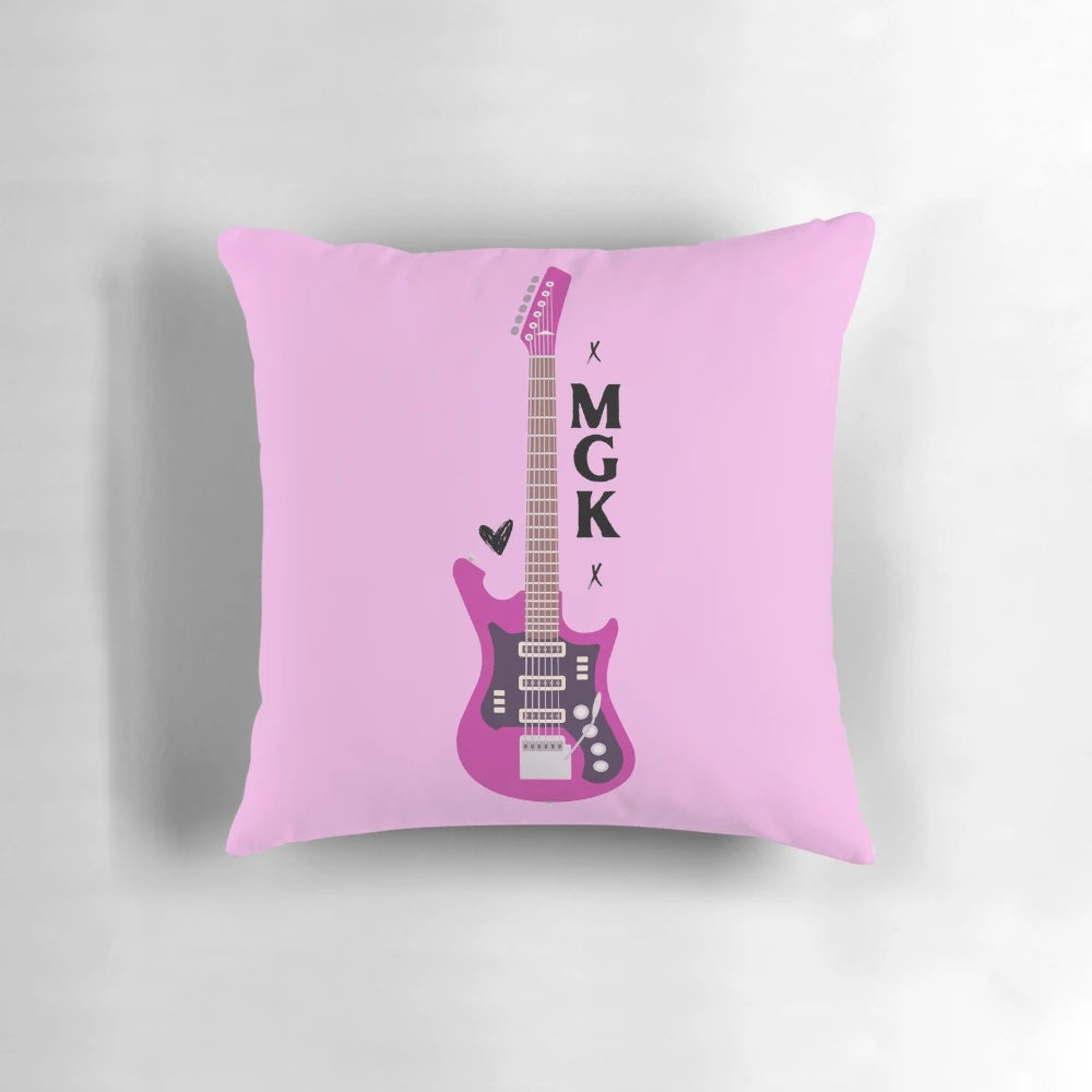Vibrant pink guitar-shaped pillow featuring the logo of punk singer Machine Gun Kelly