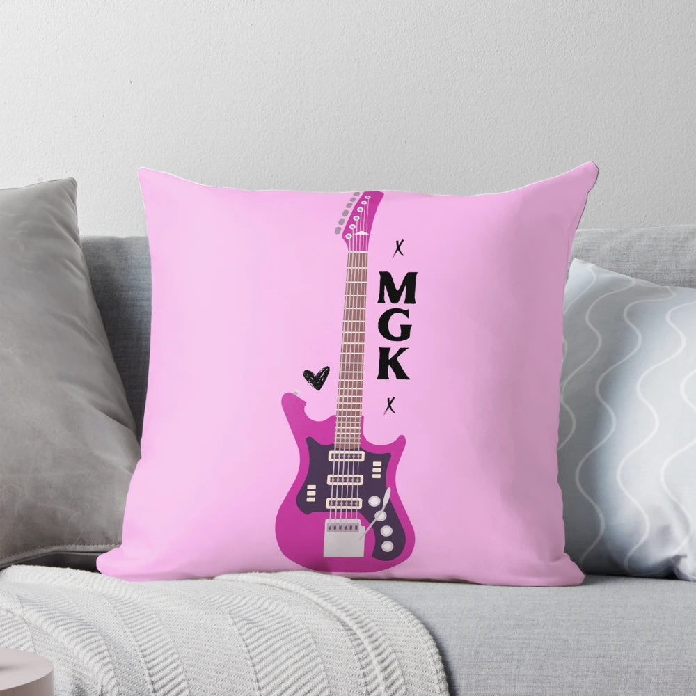 Vibrant pink guitar-shaped pillow featuring the logo of punk singer Machine Gun Kelly