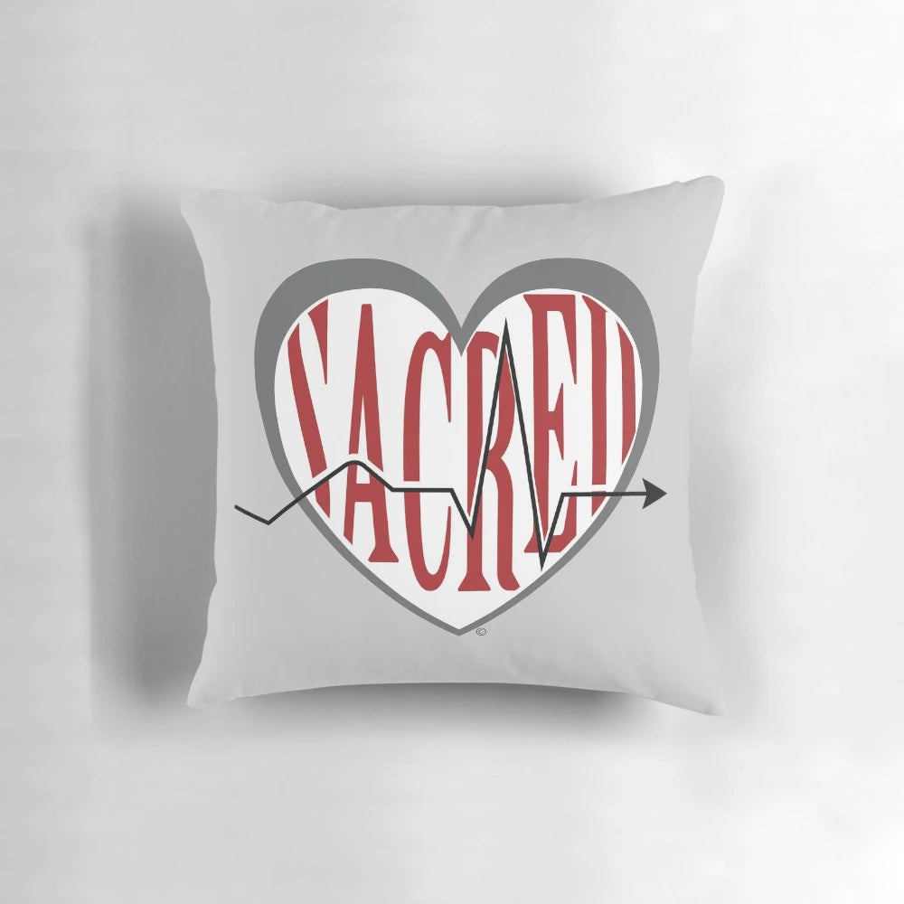 Sacred Heart University logo printed on a red and white pillow for laptops and studying.