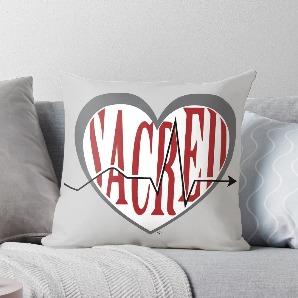 Sacred Heart University logo printed on a red and white pillow for laptops and studying.