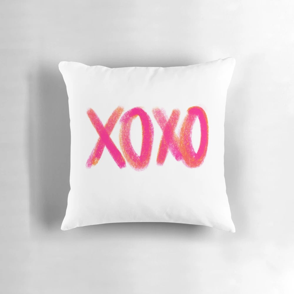 A soft and comfortable decorative throw pillow in a pink and orange XOXO design, perfect for adding a touch of girly style to any room.