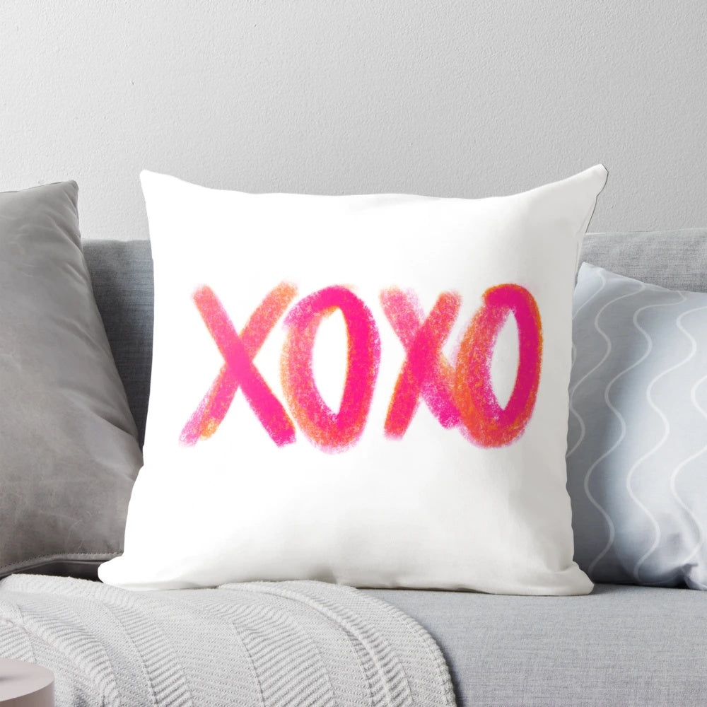 A soft and comfortable decorative throw pillow in a pink and orange XOXO design, perfect for adding a touch of girly style to any room.