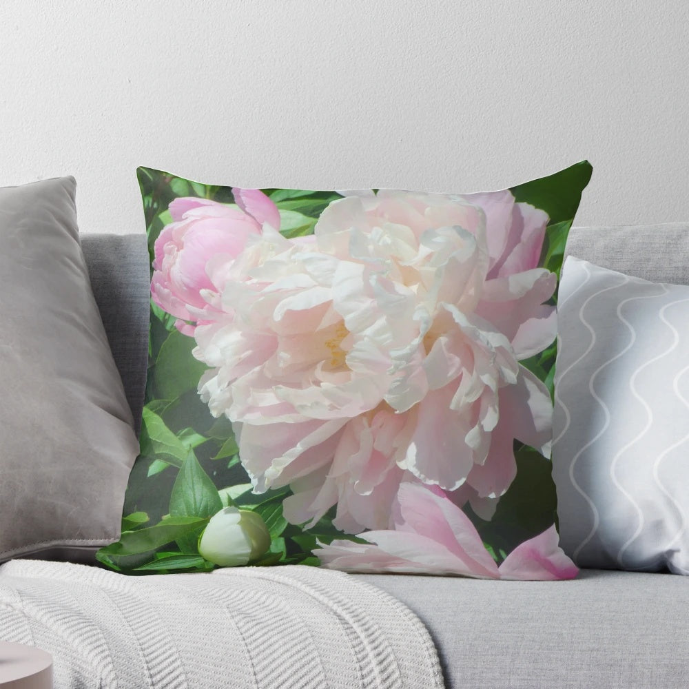 Lush pink peony flowers on a soft, plush throw pillow