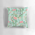 A soft, blue-green pillow featuring a Japanese-inspired pattern of bamboo, birds, and blossoms.