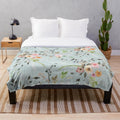 Soft and delicate blue floral plush blanket for a romantic, boho-inspired bedroom