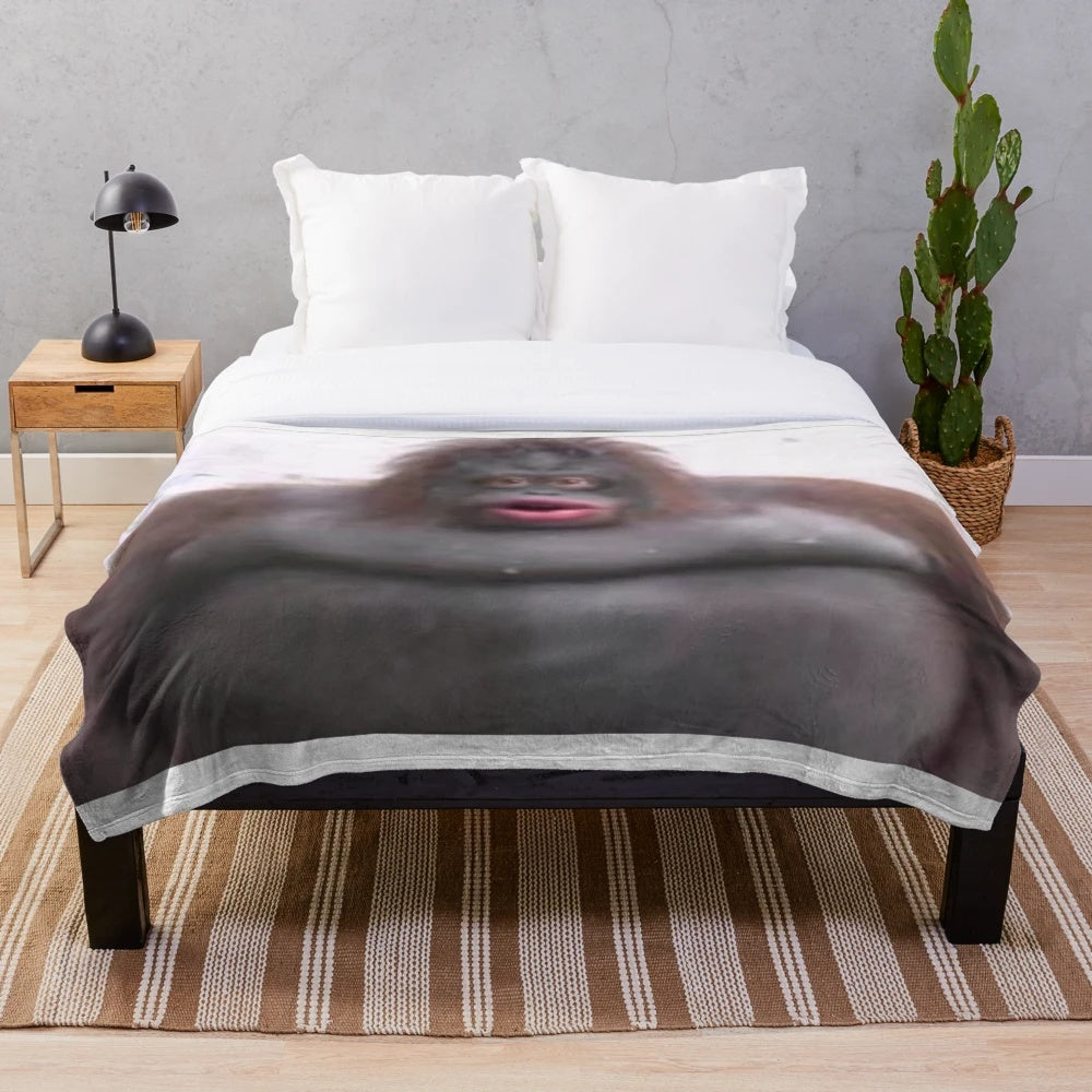 Soft and plush Le Monke blanket with a cute monkey design, perfect for snuggling