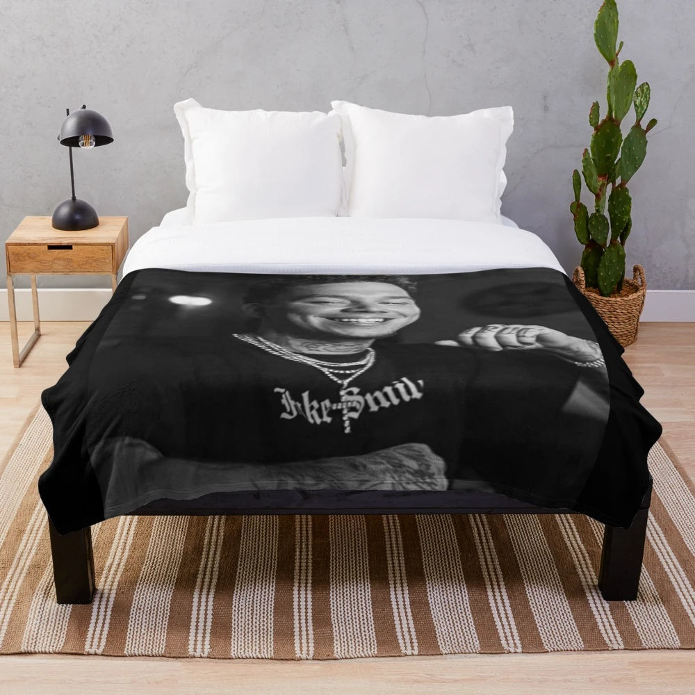Soft and cozy Phora plush blanket with "Love is Hell" design