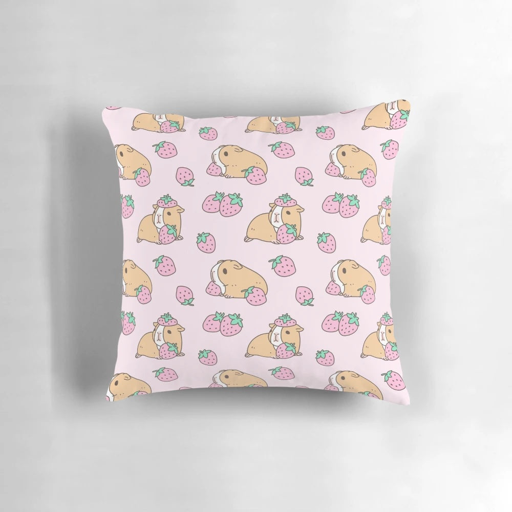 Plush pink pillow with a whimsical guinea pig and strawberry pattern, perfect for adding a touch of cute to any room.