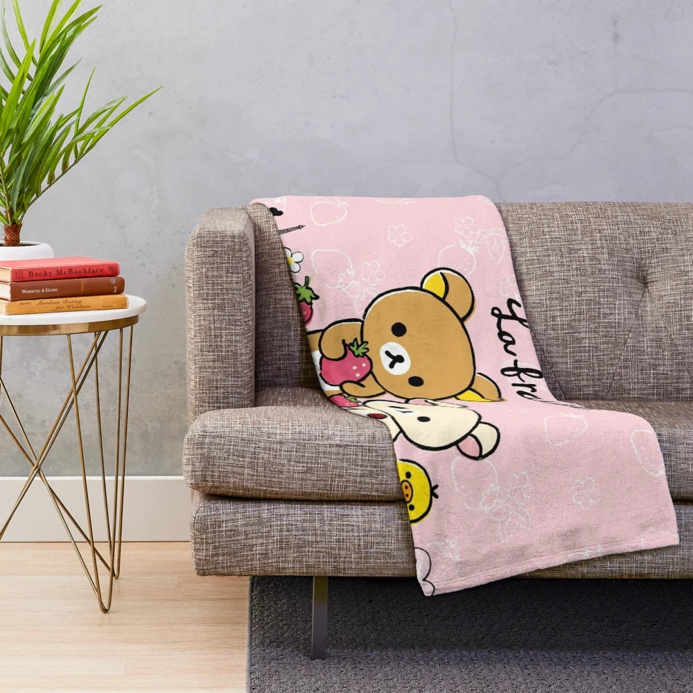 Rilakkuma-inspired plush blanket with a cute strawberry design