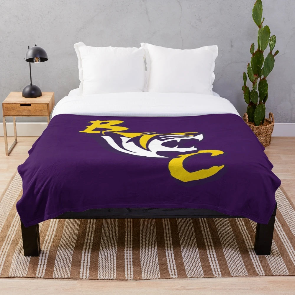 A soft and plush blanket featuring the Benedict Tigers mascot and school colors