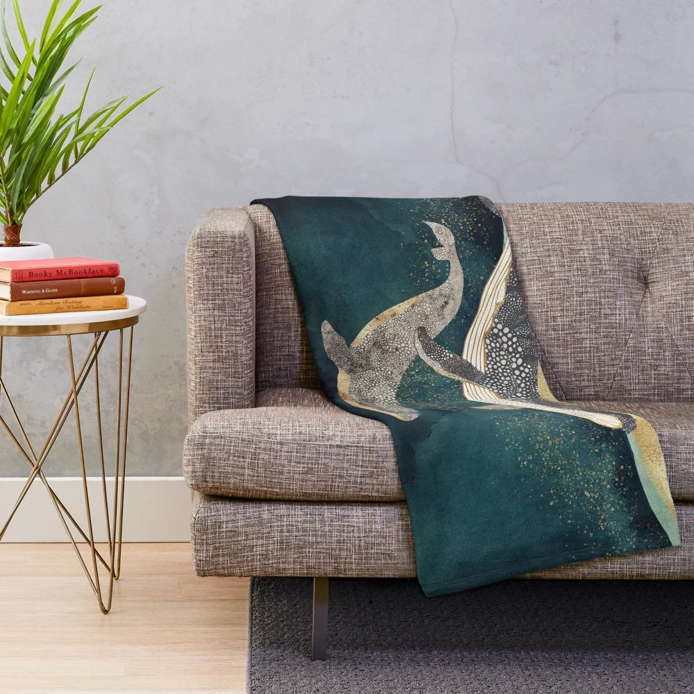 Soft and cozy plush blanket with a whale and ocean-inspired design