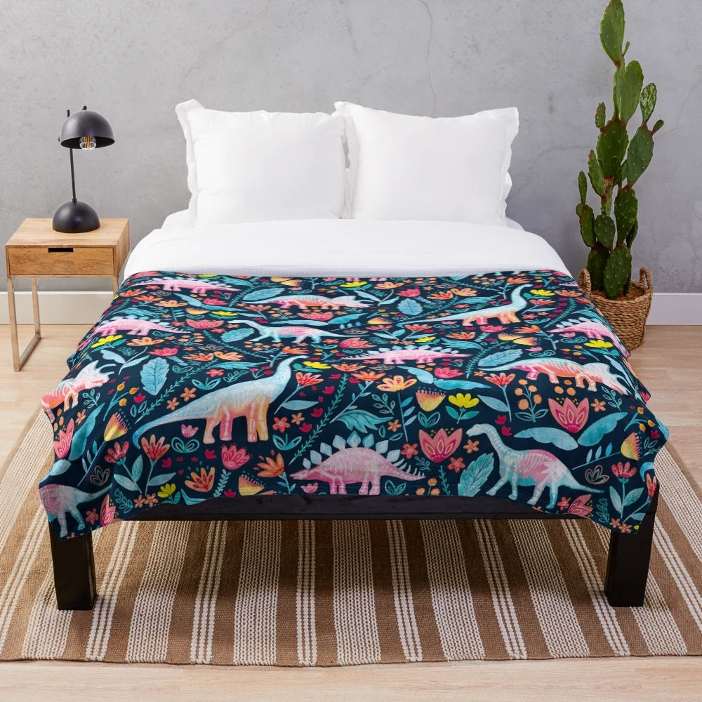 Soft and cozy dinosaur-themed plush blanket with a botanical floral design