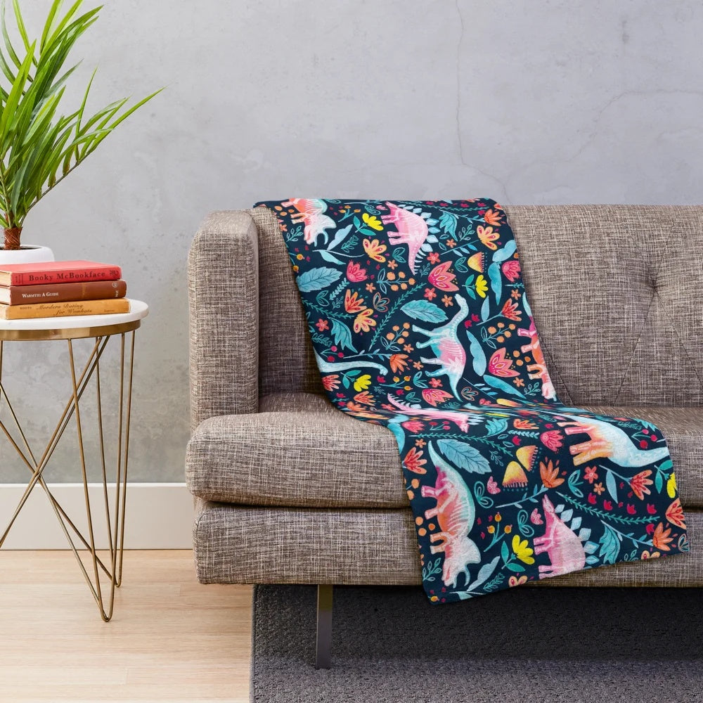 Soft and cozy dinosaur-themed plush blanket with a botanical floral design