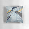 A soft, modern geometric mosaic pillow in navy, blue, and gold tones.