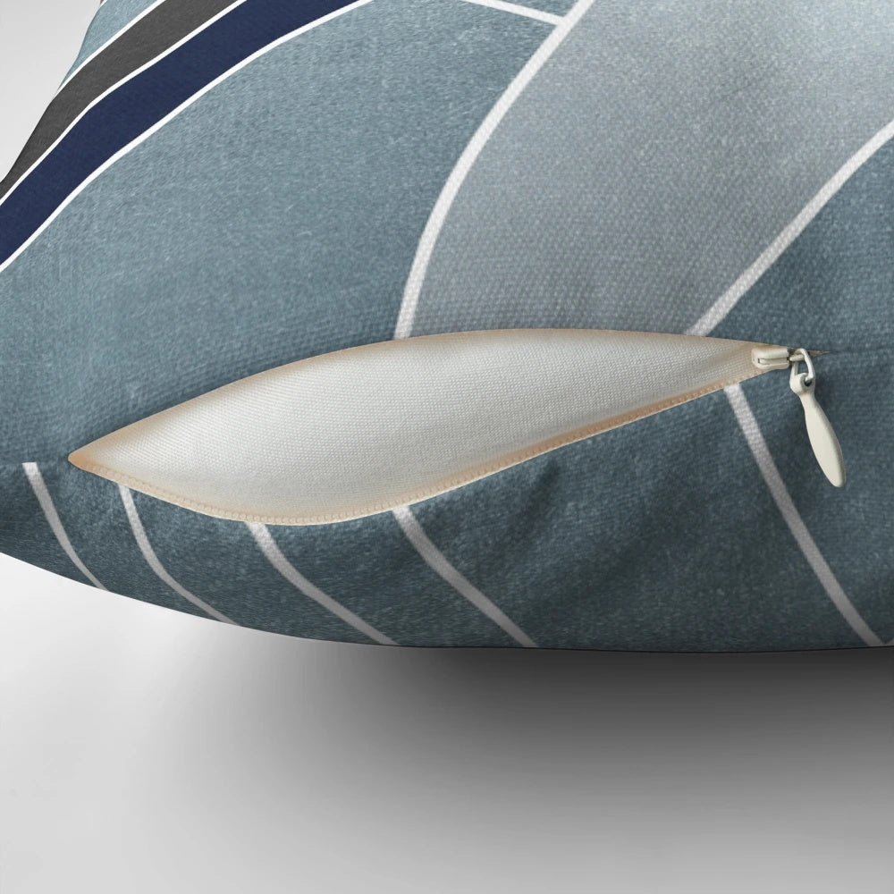 A soft, modern geometric mosaic pillow in navy, blue, and gold tones.