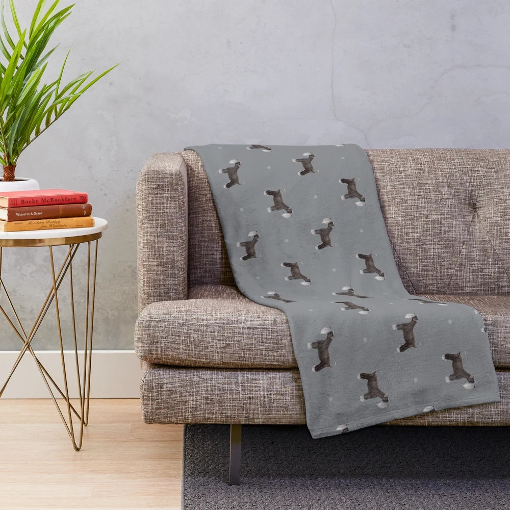 Soft grey plush blanket with a side-facing schnauzer repeat pattern