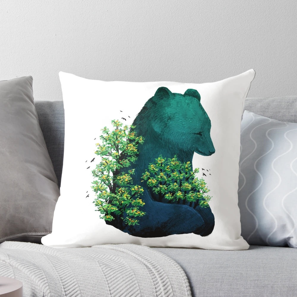 A soft, decorative pillow featuring a nature-inspired design with a bear hugging a tree surrounded by birds and a colorful landscape.