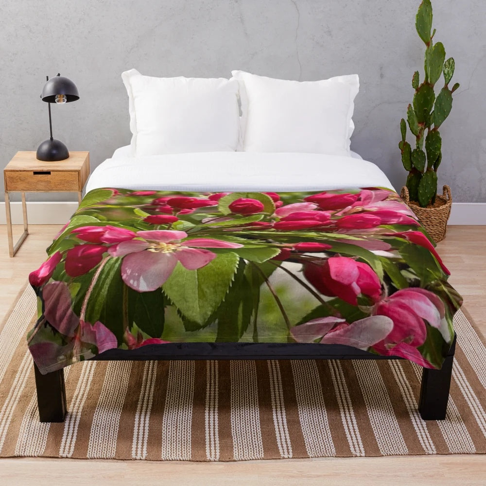 Plush blanket featuring a pink flowering tree design