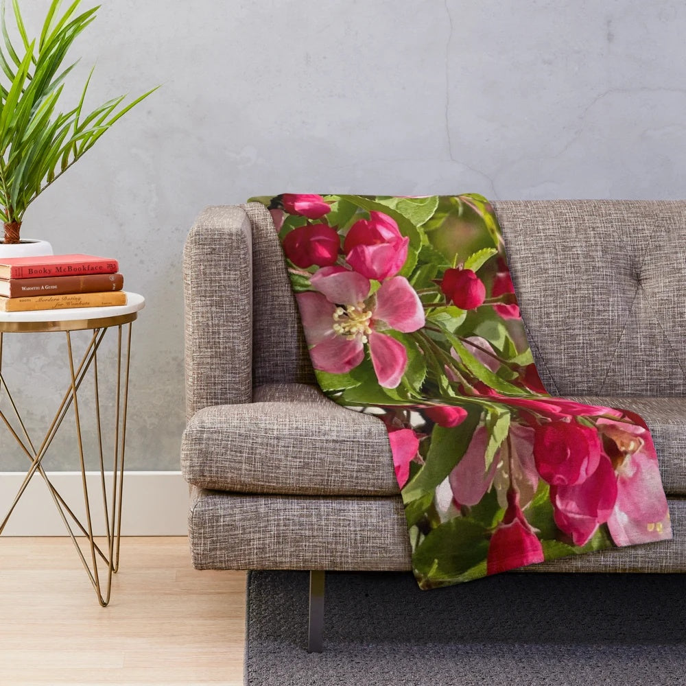 Plush blanket featuring a pink flowering tree design