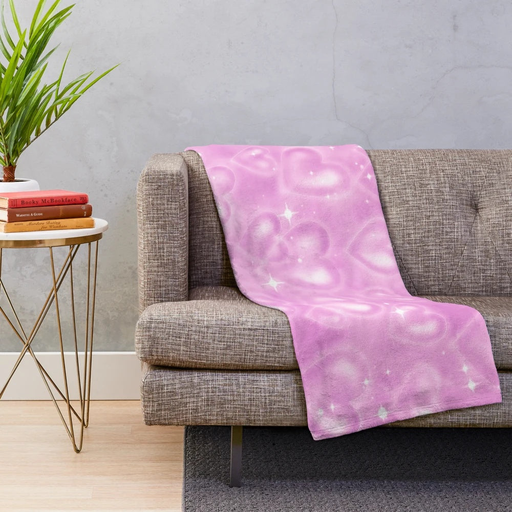 Soft pink plush blanket with a 90s heart backdrop design
