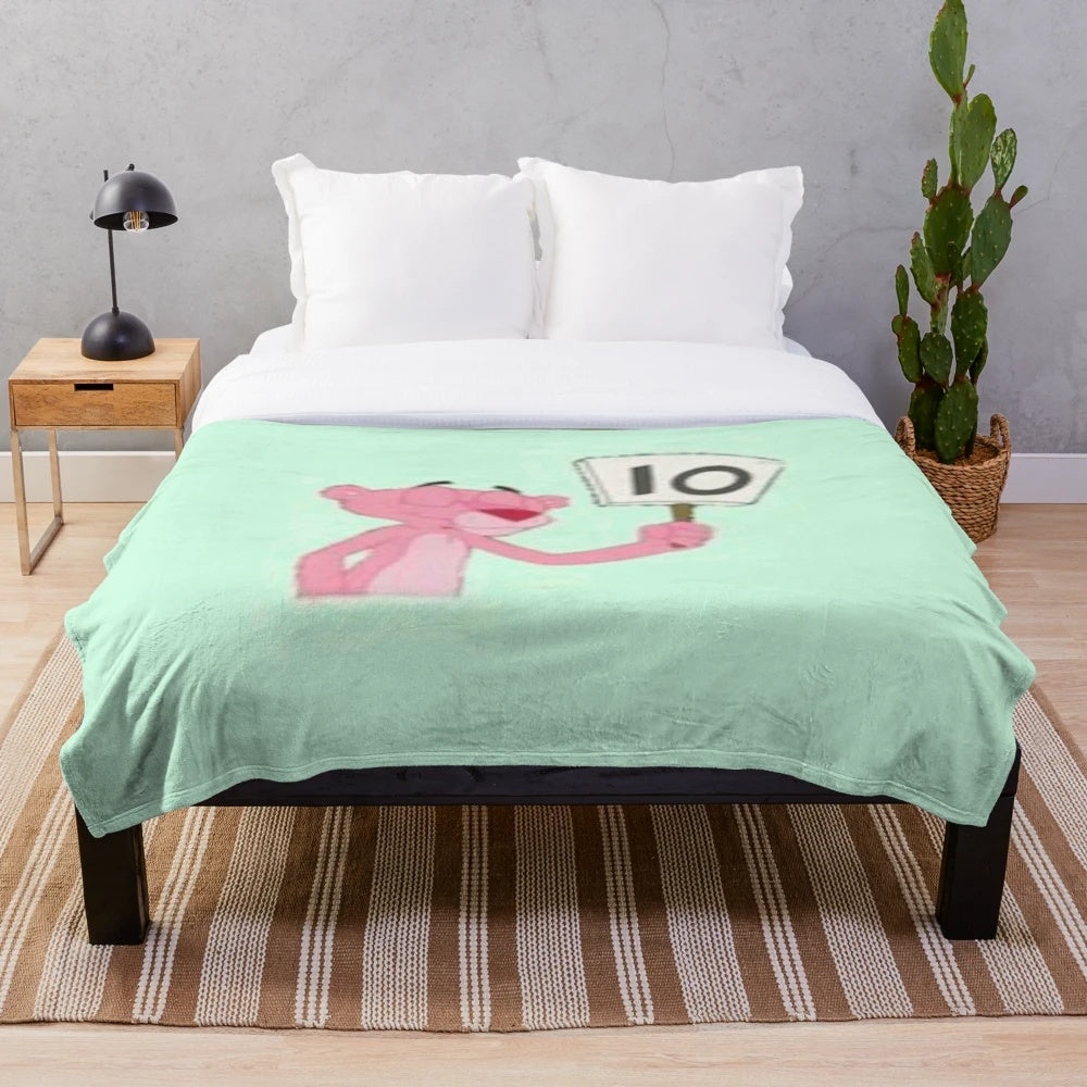 Soft pink plush blanket featuring a cartoon character design