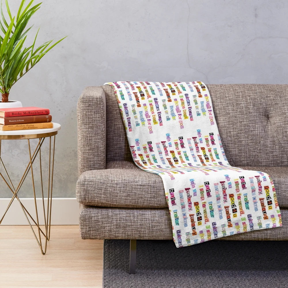 Soft plush blanket decorated with song titles from Olivia Rodrigo's album Sour
